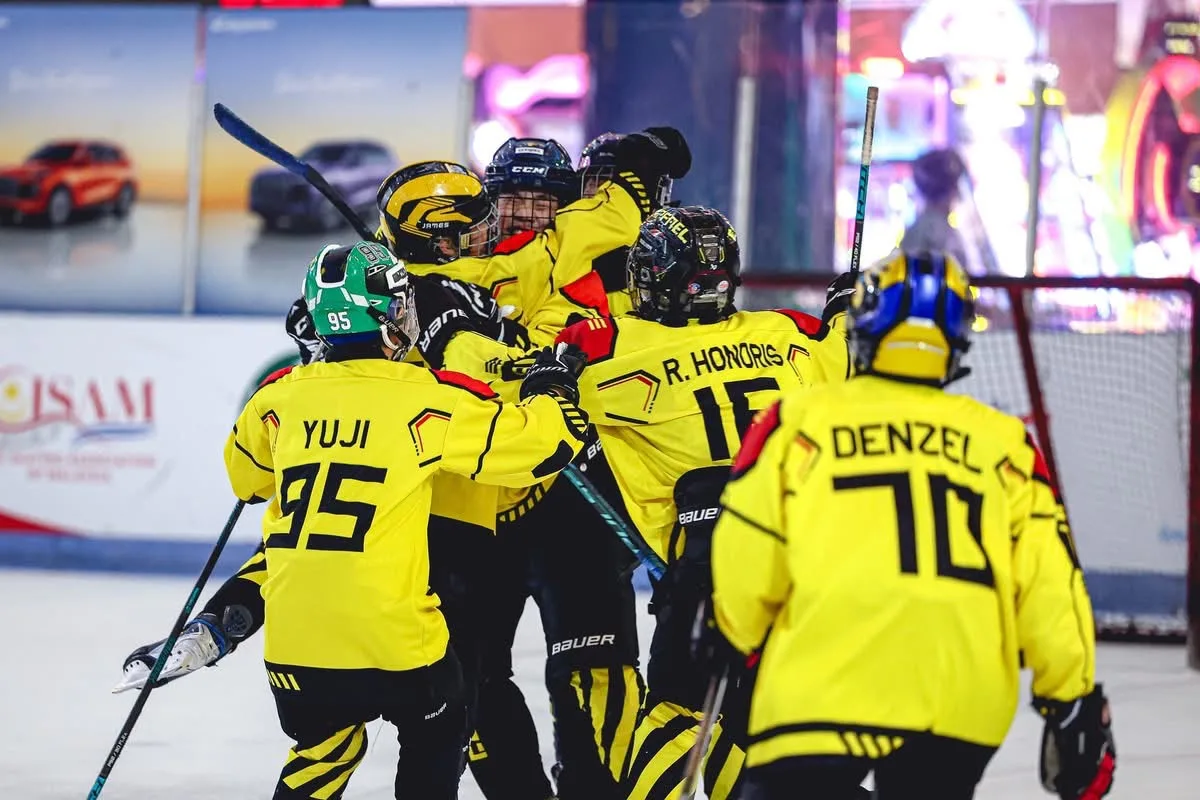 U13 Golden Cobras players hugging after a goal at Frozen Faceoff 2026